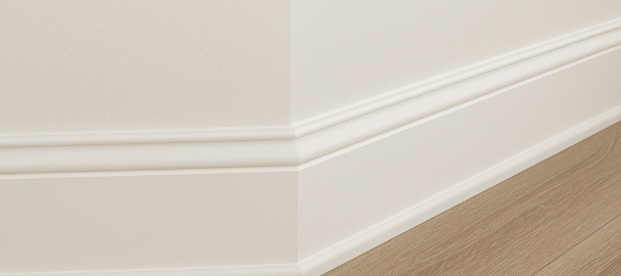 Detalle de molduras de madera instaladas entre muro y piso laminado en un espacio interior